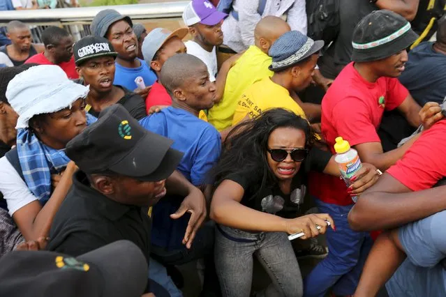 A student reacts during their confrontation with security guards as they protest over planned increases in tuition fees outside the (UJ) University of Johannesburg, October 22, 2015. (Photo by Siphiwe Sibeko/Reuters)