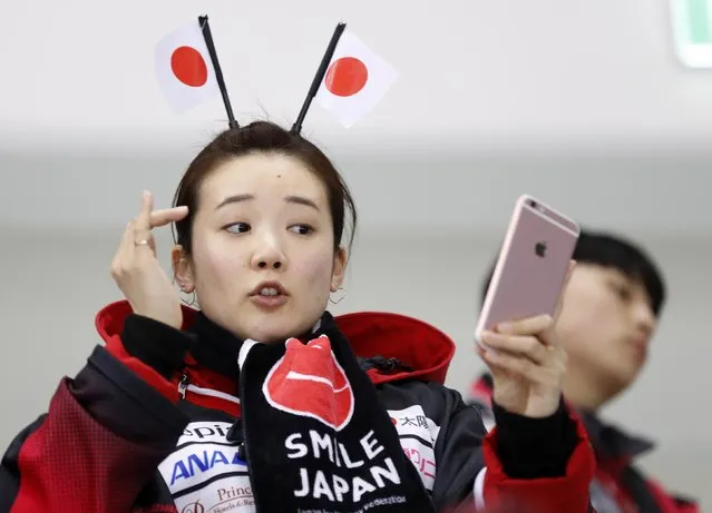 A Japan fan takes a selfie before the women' s classifications (5-8) ice hockey match between Sweden and Japan during the Pyeongchang 2018 Winter Olympic Games at the Kwandong Hockey Centre in Gangneung on February 18, 2018. (Photo by Kim Kyung-Hoon/Reuters)