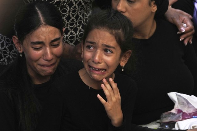 The family of Israeli Defense Force Staff Sgt. Noam Aharon Musgadian, who was killed in action in the Gaza Strip, weeps at his grave during his funeral at Mt. Herzl Military Cemetery in Jerusalem, Tuesday, July 8, 2025. (Photo by Maya Alleruzzo/AP Photo)
