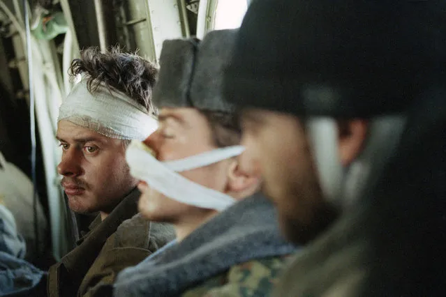 In this February 3, 1995 file photo, a wounded Russian soldier, being evacuated with his comrades, look on, in a helicopter on his way out of Grozny, as the fighting in the Chechen capital continues. (Photo by Karsten Thielker/AP Photo/File)