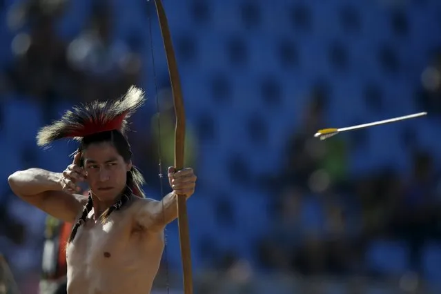 An indigenous man from the U.S. fires an arrow during the bow-and-arrow competition at the first World Games for Indigenous Peoples in Palmas, Brazil, October 26, 2015. (Photo by Ueslei Marcelino/Reuters)