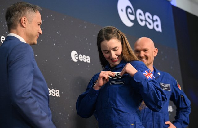 Alexander Gerst (R), astronaut of the European Space Agency (ESA), looks on as ESA astronaut graduate Rosemary Coogan attaches her new badge during a graduation ceremony on April 22, 2024 at the European Astronaut Centre (EAC) in Cologne, western Germany. Five ESA astronaut candidates and one Australian astronaut candidate took up duty at the European Astronaut Centre one year ago to be trained to the highest level of standards as specified by the International Space Station partners. After successful completion of basic training, they now are graduate. (Photo by Ina Fassbender/AFP Photo)