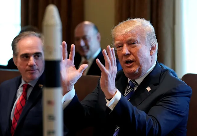 With a rocket ship on the table, U.S. President Donald Trump speaks about the space program during a cabinet meeting at the White House in Washington, U.S., March 8, 2018. (Photo by Kevin Lamarque/Reuters)