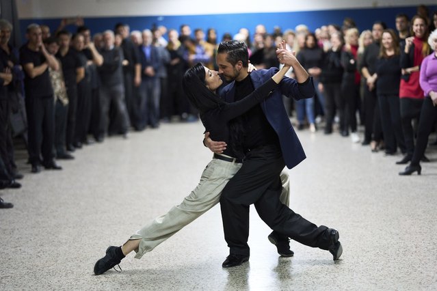 Tango teachers Laura Murphy and Fransley Marcel explain how to perform a traditional tango pose in a tango school held as part of the Tango Festival in Buenos Aires, Argentina, Saturday, August 23, 2025. (Photo by Rodrigo Abd/AP Photo)