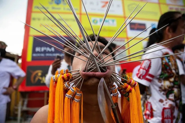 Thai devotees are possessed by spirits and pierced with long needles during a Vegetarian ritual at the Sapam Shrine on October 19, 2020 in Phuket, Thailand. Thailand holds its first major festival since COVID-19 lockdown restrictions were put in place in March of 2020. The annual Vegetarian Festival in Phuket, where devotees follow a strict vegetarian diet to celebrate the 9 Emperor Gods, remains one of the most popular events in Thailand. This year, the Thai government hopes that allowing the festival to happen despite emergency decrees will help boost the suffering local economy. The Phuket airport is expected to receive nearly 15,000 domestic travellers per day throughout the duration of the 9 day festival, generating millions of baht. Over the course of the pandemic Phuket has been one of the hardest hit areas in Thailand, with 80% of the island's profits reliant on foreign visitors and tens of thousands unemployed. (Photo by Lauren DeCicca/Getty Images)