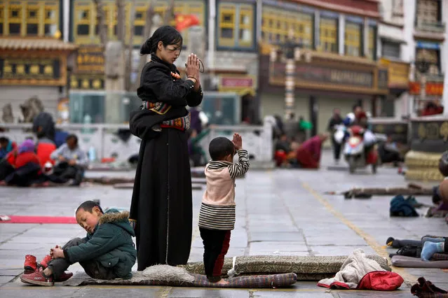 Tibetans pray outside Jokhang Monastery ahead of Tibetan New Year's Day in Lhasa, Tibet autonomous region, February 28, 2014. The Tibetan New Year occurs on March 1 this year. (Photo by Jacky Chen/Reuters)