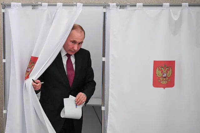 Russian President and Presidential candidate Vladimir Putin at a polling station during the presidential election in Moscow, Russia March 18, 2018. (Photo by Yuri Kadobnov/Reuters)
