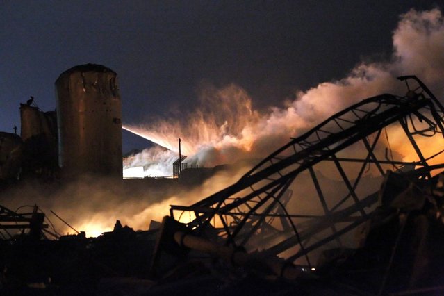 Smoke rises as water is sprayed at the burning remains of a fertilizer plant after an explosion at the plant in the town of West, near Waco, Texas early April 18, 2013. (Photo by Mike Stone/Reuters)