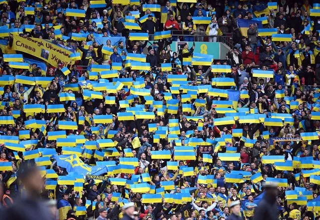 Ukraine supporters hold up flags during the anthems ahead of the UEFA Euro 2024 group C qualification football match between England and Ukraine at Wembley Stadium in London on March 26, 2023. (Photo by Justin Tallis/AFP Photo)