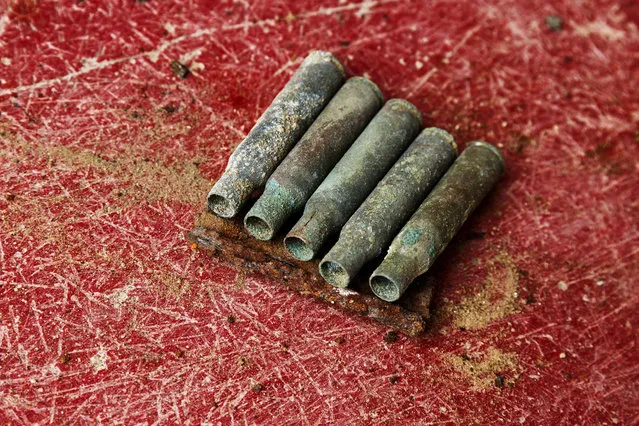 This photo taken on December 17, 2014, shows bullet shells found during the exhumation of a mass grave of those killed by their political ideology during and after the spanish civil war at the Puerto Real cemetery are displayed to be pictured by the photographer in Puerto Real, Spain. (Photo by Daniel Ochoa de Olza/AP Photo)