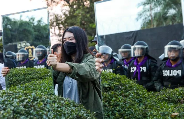 Protesters hold mirrors in front of riot police officers during a pro-democracy rally demanding the prime minister to resign and reforms on the monarchy, at 11th Infantry Regiment, in Bangkok, Thailand, November 29, 2020. (Photo by Soe Zeya Tun/Reuters)