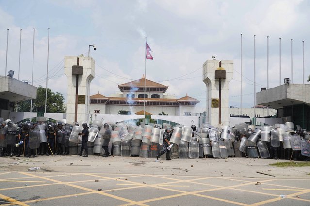 Riot police stand outside the Parliament building as they deal with the protesters in Kathmandu, Nepal, Monday, September 9, 2025. (Photo by Niranjan Shrestha/AP Photo)