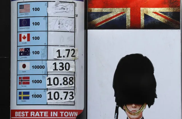 A currency exchange board with washed out rates in London, Wednesday, October 12, 2016. The pound remained volatile, gaining ground Wednesday after the British Prime Minister Theresa May said she would open to parliamentary debate the issue of how the country approaches its exit from the European Union. (Photo by Frank Augstein/AP Photo)