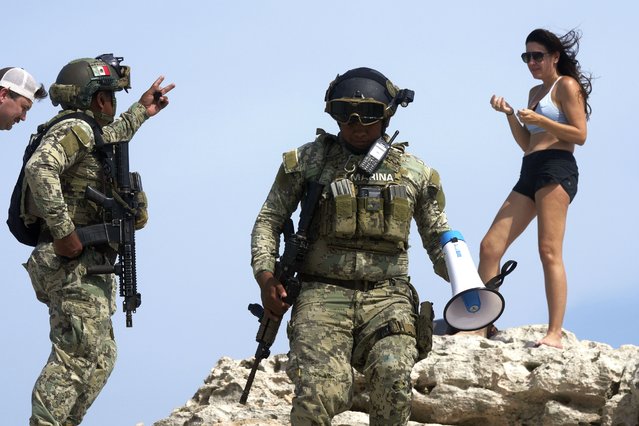 Soldiers ask a tourist to evacuate Mirador beach ahead of Hurricane Beryl's expected arrival in Tulum, Mexico, July 4, 2024. (Photo by Fernando Llano/AP Photo)