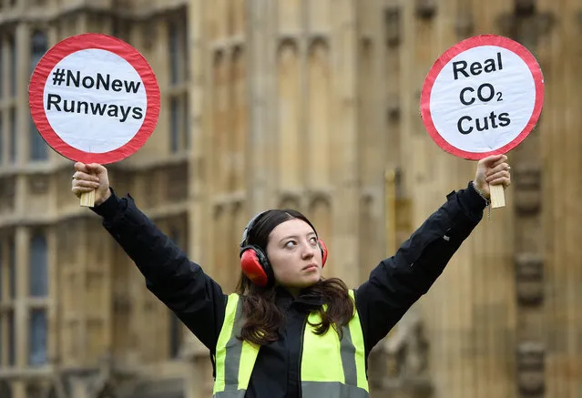 Protestors from Plane Stupid stage a demonstration with a mock runway outside the Houses of Parliament in London, Britain, 25 October 2016. The UK government is expected to announce the long-awaited decision on airport expansion, with Heathrow running as the favourite. (Photo by Facundo Arrizabalaga/EPA)