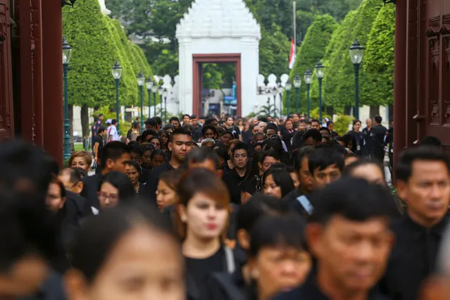 Mourners walk in line into the Throne Hall at the Grand Palace for the first time to pay respects to the body of Thailand's late King Bhumibol Adulyadej that is kept in a golden urn in Bangkok, Thailand, October 29, 2016. (Photo by Athit Perawongmetha/Reuters)