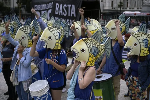 Members of environmental organization Extinction Rebellion protest disguised as fishes on International Water Day in Buenos Aires, on March 22, 2022. (Photo by Juan Mabromata/AFP Photo)