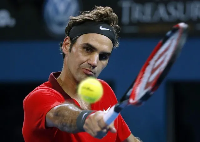 Roger Federer of Switzerland plays a backhand return to James Duckworth of Australia in their men's singles quarter-final match at the Brisbane International tennis tournament in Brisbane, January 9, 2015. (Photo by Jason Reed/Reuters)