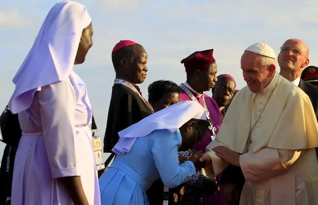 Pope Francis meets nuns and members of the clergy upon his arrival at the Entebbe international airport near the capital Uganda, November 27, 2015. (Photo by James Akena/Reuters)