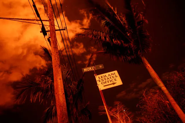 Lava illuminates a sign in Leilani Estates during ongoing eruptions of the Kilauea Volcano in Hawaii, U.S., June 9, 2018. (Photo by Terray Sylvester/Reuters)