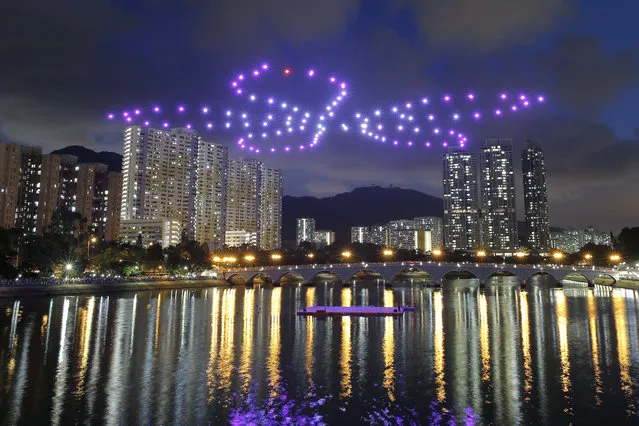 One hundred remote controlled drones form the shape of an orchid tree flower representing Hong Kong, in Hong Kong, Saturday, June 30, 2018, to celebrate the upcoming 21st anniversary of the city's return to Chinese sovereignty from British rule on July 1. (Photo by Kin Cheung/AP Photo)