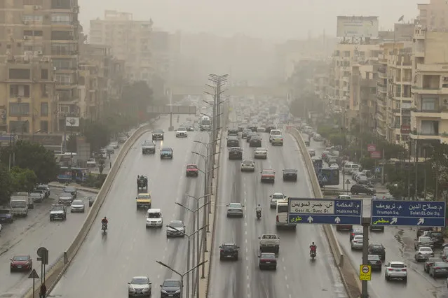 Vehicles drive along a road during a sandstorm in Cairo, Egypt, 01 June 2023. Meteorologists warned of strong winds that would stir sand throughout the city. (Photo by Khaled Elfiqi/EPA/EFE/Rex Features/Shutterstock)