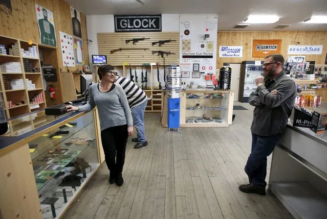 Jessie Palmieri, (L) talks to her husband Steve, (R) after she decides to buy a H&K VP9 9mm handgun, her first gun, at the Ringmasters of Utah gun range and store, in Springville, Utah on December 18, 2015. (Photo by George Frey/Reuters)