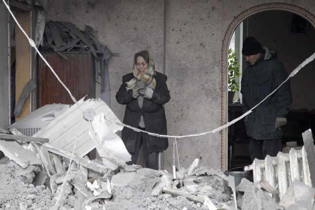 A woman reacts as she looks at the debris of her house, which according to locals was recently damaged by shelling, in the suburbs of Donetsk January 30, 2015. (Photo by Alexander Ermochenko/Reuters)