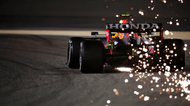 Sparks fly behind Sergio Perez of Mexico driving the (11) Red Bull Racing RB16B Honda during Day Two of F1 Testing at Bahrain International Circuit on March 13, 2021 in Bahrain, Bahrain. (Photo by Joe Portlock – Formula 1/Formula 1 via Getty Images)