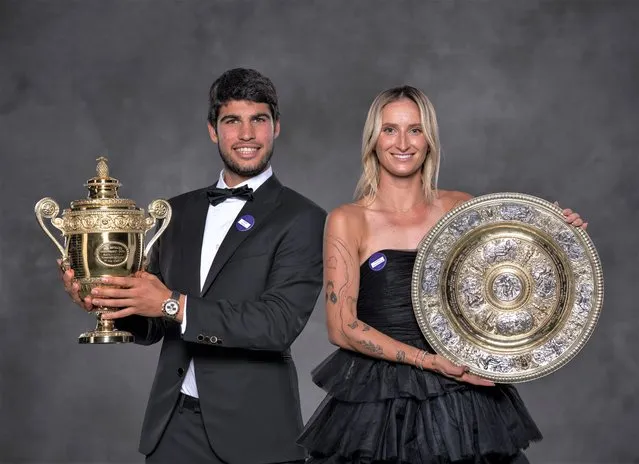 In this handout photo provided by the All England Lawn Tennis Club, Carlos Alcaraz of Spain poses with the Gentlemen's Singles Trophy and Marketa Vondrousova of the Czech Republic poses with the Venus Rosewater Dish during the Wimbledon Champions Dinner at the All England Lawn Tennis Club on July 16, 2023 in London England. (Photo by Thomas Lovelock/AELTC via Getty Images)