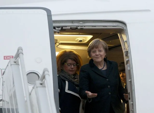 Germany's Chancellor Angela Merkel (front) walks out of a plane upon her arrival at an airport near Minsk, February 11, 2015. (Photo by Valentyn Ogirenko/Reuters)