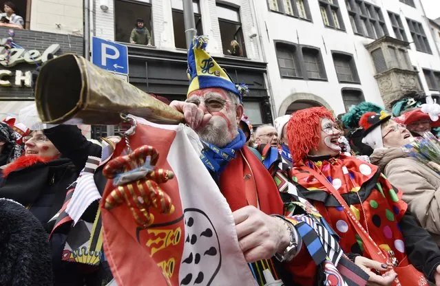 Revelers celebrate  during the traditional carnival parade in Cologne, western Germany, Monday, February 16, 2015. (Photo by Martin Meissner/AP Photo)