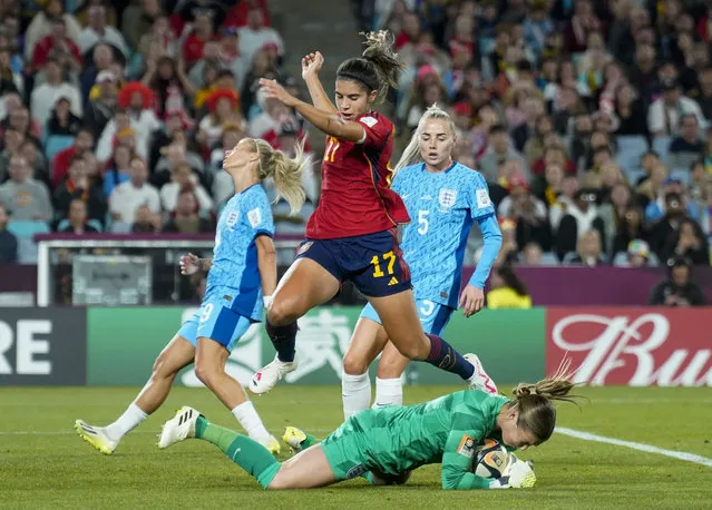 Spain forward Alba Redondo (17) leaps over England goalkeeper Mary Earps (1) as she dives on the ball for a save during the FIFA Women's World Cup  2023 Final match between Spain and England on Sunday, August 20, 2023, at Stadium Australia in Sydney, Australia, (Photo by Jabin Botsford/The Washington Post)