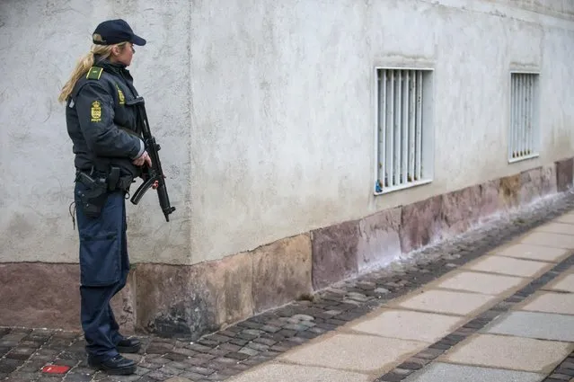 A police secures the police headquarters in Copenhagen, February 15, 2015. Danish police said they believed the man shot dead by officers in Copenhagen on Sunday was responsible for two shootings in the city at a freedom of expression event and a synagogue which killed two people and wounded five. (Photo by Hannibal Hanschke/Reuters)