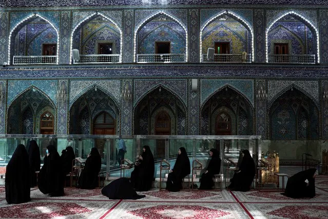 Women sit at Imam Abbas shrine during the holy month of Ramadan in Kerbala, Iraq, April 22, 2021. (Photo by Abdullah Dhiaa Al-deen/Reuters)