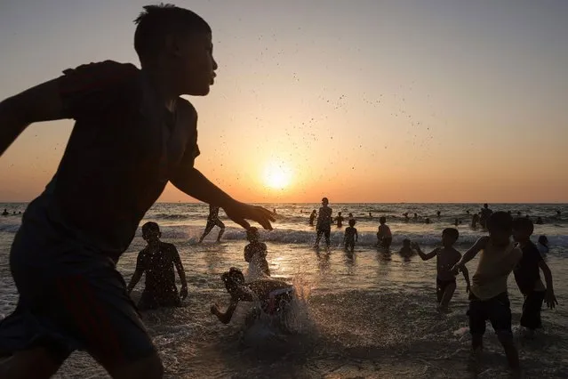 Children play in the water at the beach in Gaza City on July 27, 2023, amidst soaring temperatures and power cuts. (Photo by Mohammed Abed/AFP Photo)