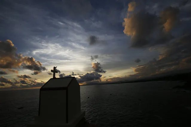 In this June 21, 2018 photo, the sun sets over the fisherman's cove in Acapulco, Mexico. Last year, authorities opened investigations into 834 murders in Acapulco. (Photo by Bernandino Hernandez/AP Photo)