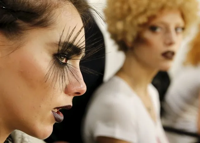 Models prepare backstage before presenting makeup creations during a show by Maybelline New York at the Berlin Fashion Week Autumn/Winter 2016 in Berlin, Germany, January 18, 2016. (Photo by Fabrizio Bensch/Reuters)