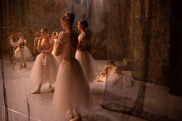 Ballet dancers are seen onstage before the ballet performance Giselle begins June 10, 2022 in Lviv, Ukraine. The Lviv National Opera house resumed performances last month for both ballet and opera. The bomb shelter can only hold 300 people so tickets are limited in case a siren goes off during the performance. (Photo by Paula Bronstein/Getty Images)