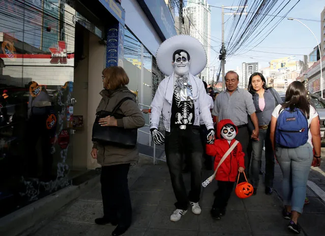 People in costume walk during Halloween celebration in La Paz, Bolivia on October 31, 2018. (Photo by David Mercado/Reuters)