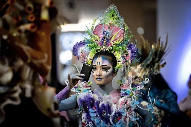 A model prepares backstage during the body painting show : Miracle World The Ocean organized by Unipa Surabaya at Grand Atrium Royal Plaza on June 21, 2021 in Surabaya, Indonesia. (Photo by Robertus Pudyanto/Getty Images)