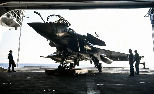 A French Navy Rafale fighter jet is seen aboard the upgraded aircraft carrier Charles de Gaulle, off the coast of Toulon, France, November 14, 2018. Europe's only nuclear-powered aircraft carrier, the 260-meter-long (850-ft) vessel, which carries 1,700 personnel and whose tonnage is equal to four Eiffel Towers, is due to be deployed in early February 2019 in the Indian Ocean, according to military sources. (Photo by Christophe Simon/Reuters)