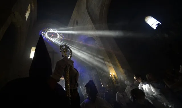 Hooded penitents from “El Calvario” brotherhood take part during a Holy Week procession in Cordoba, Spain, Wednesday, April 1, 2015. (Photo by Manu Fernandez/AP Photo)