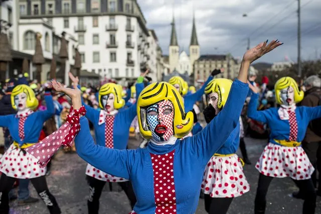 Masked revelers  parade through the streets during the start of the carnival  in Lucerne, Switzerland, Monday, February 8, 2016. (Photo by Alexandra Wey/Keystone via AP Photo)