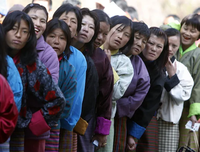 Voters stand outside a polling station to cast their ballot in Thimpu, Bhutan, March 2008. (Photo by Desmond Boylan/Reuters)