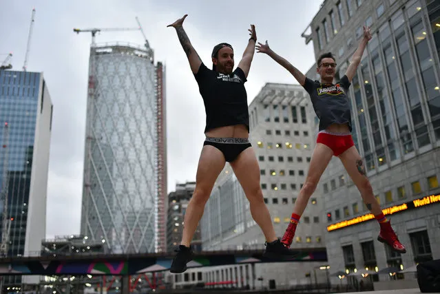 People take part in the annual “No Trousers On The Tube Day” (No Pants Subway Ride) on the London Underground Jubilee Line, posing for photographs at Canary Wharf, in London on January 13, 2019. The No Pants Day (Trousers in UK) is a participatory annual event that has happened in various nations. It requires wearing just undergarments in the lower part of body in public. (Photo by Alberto Pezzali/NurPhoto via Getty Images)