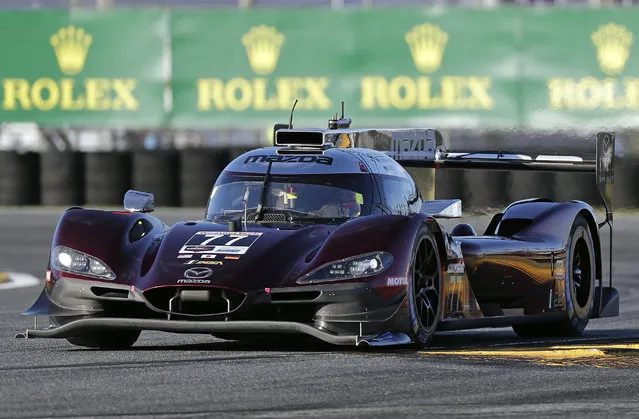 Oliver Jarvis of Great Britain, drives his Mazda DPi through a horseshoe turn whiile qualifying for the pole position in the IMSA 24 hour race at Daytona International Speedway, Thursday, January 24, 2019, in Daytona Beach, Fla. (Photo by John Raoux/AP Photo)