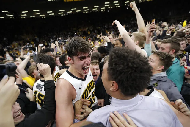 Iowa forward Luka Garza, center, celebrates with teammate Cordell Pemsl, right, after the team's NCAA college basketball game against Michigan, Friday, February 1, 2019, in Iowa City, Iowa. Garza scored 19 points as Iowa won 74-59. (Photo by Charlie Neibergall/AP Photo)