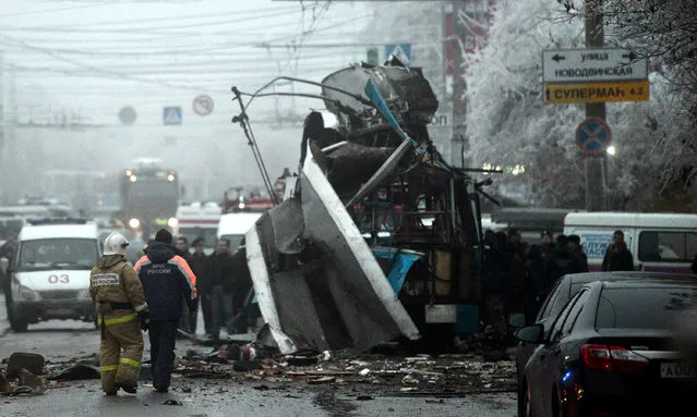 Russian firefighters and security personnel inspect the destroyed trolleybus in Volgograd on December 30, 2013. Ten people were killed in a bombing that destroyed a packed trolleybus in the southern Russian city of Volgograd, the second attack in the city in two days after a suicide strike on its main train station, officials said. (Photo by AFP Photo)