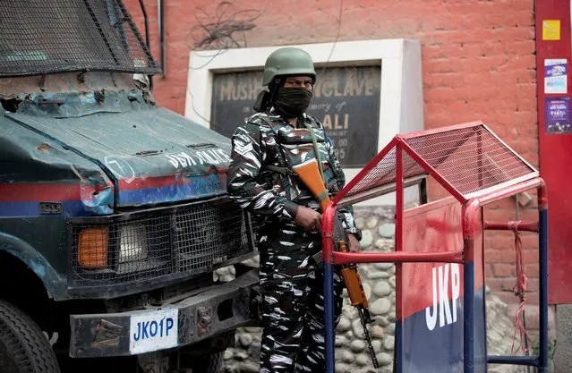 An Indian paramilitary soldier stands guard at the entrance of Press Enclave, which houses several newspaper offices, in Srinagar, Indian-controlled Kashmir, Wednesday, September 8, 2021. Police raided the homes of four journalists on Wednesday, triggering concerns of a further crackdown on press freedom in the disputed region. After the raids in Srinagar, the region’s main city, the four journalists were summoned to local police stations where they were questioned. Police did not specify the reason for the raids. (Photo by Mukhtar Khan/AP Photo)